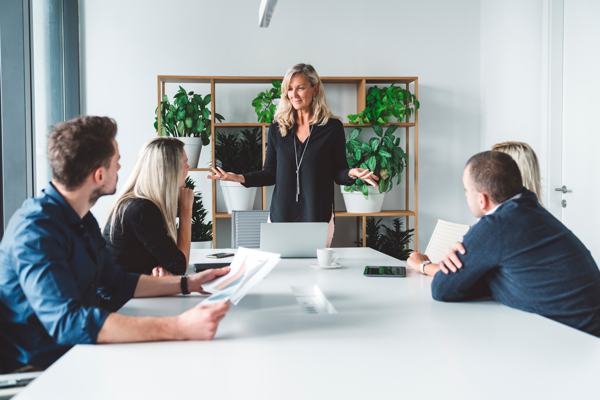 Senior woman CEO having a meeting with her colleagues in modern conference room
